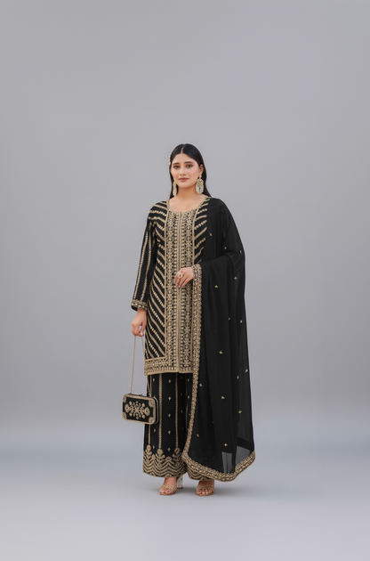 Woman wearing a black and gold embroidered traditional outfit with a garden background